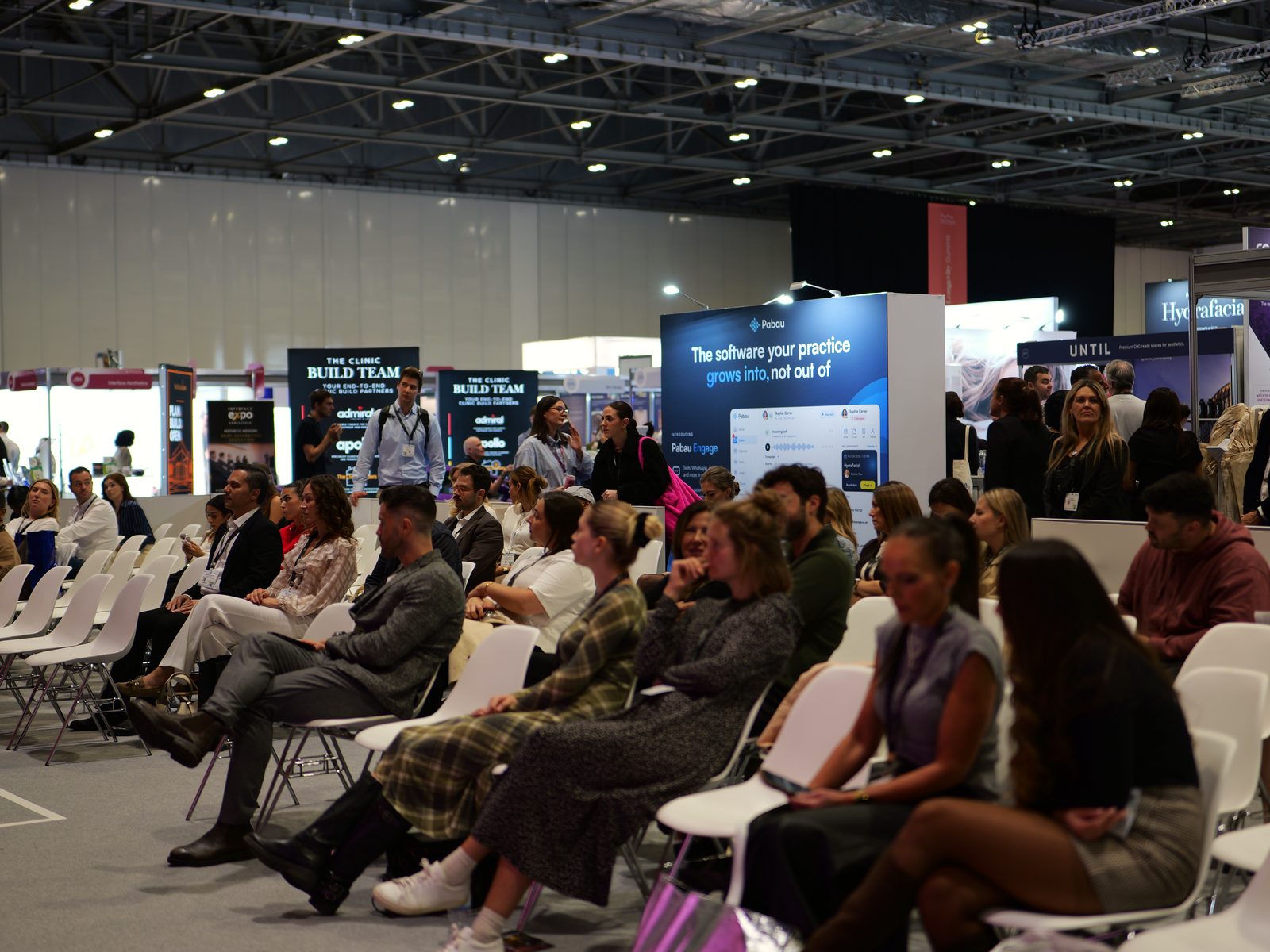 Delegates seated on the CCR exhibition floor, photographed by Kyros